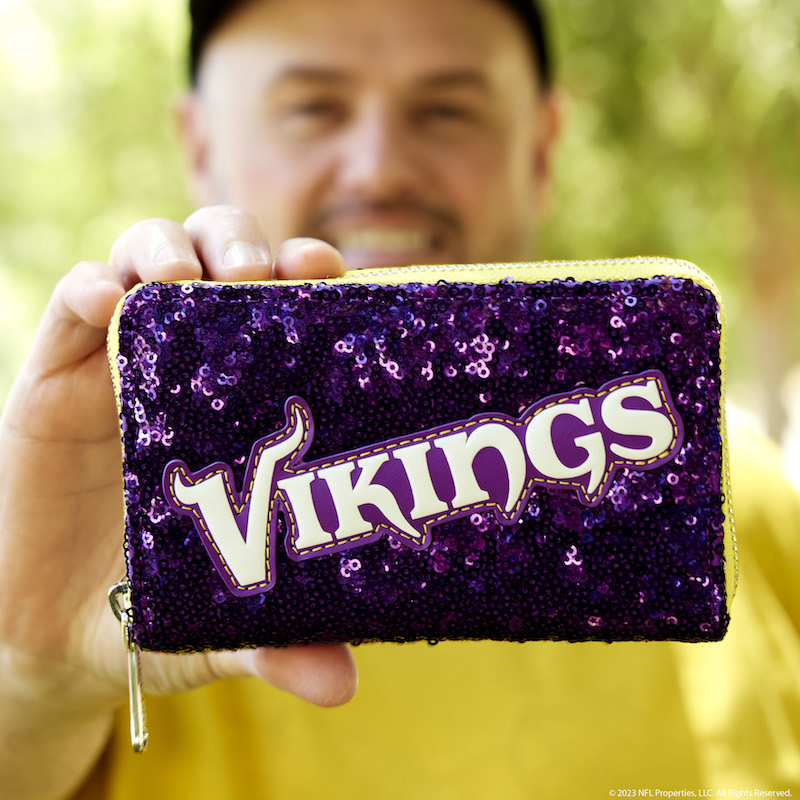 Image of man holding the NFL Minnesota Vikings Sequin Wallet out to camera 